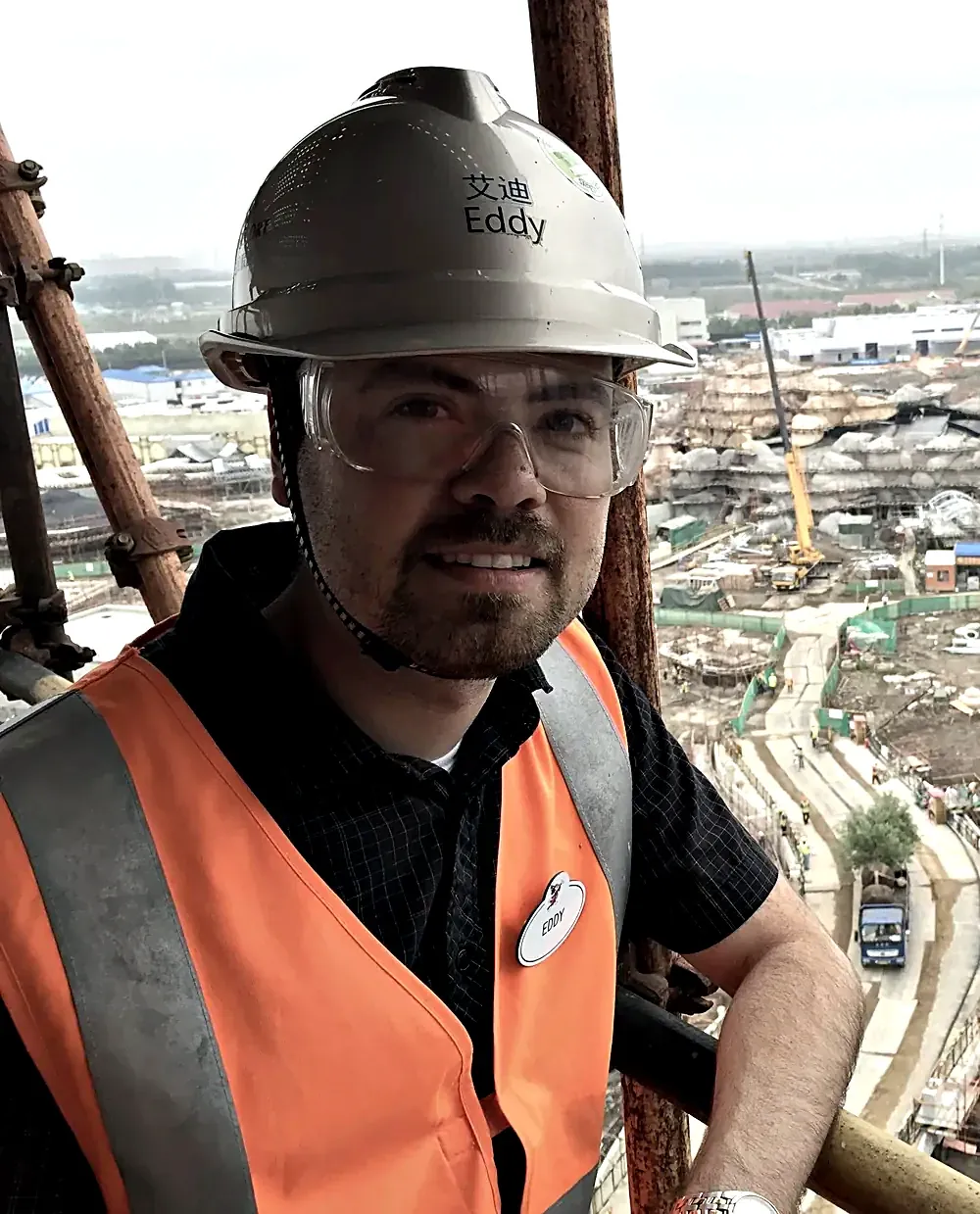 Eddy Castaneda, founder of SureSight, in a hard hat and safety gear on a ride-system construction site