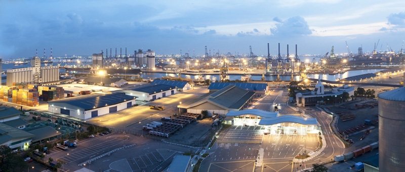Panoramic view of Jurong Port, Singapore, lined with cranes and cargo wharves