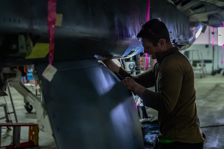A maintainer safety-wiring landing gear hardware during phase maintenance