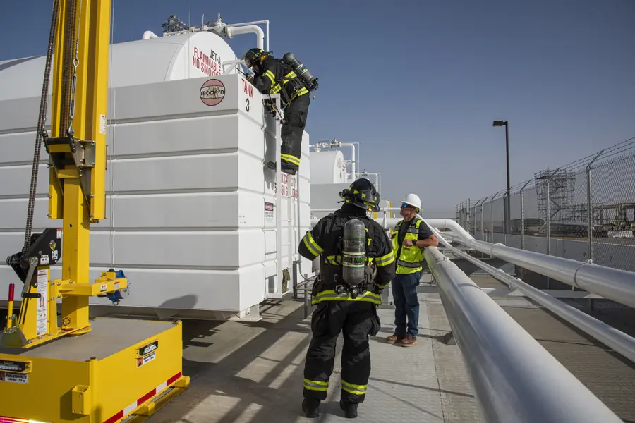 Firefighters testing the air at a confined-space entry during a training exercise