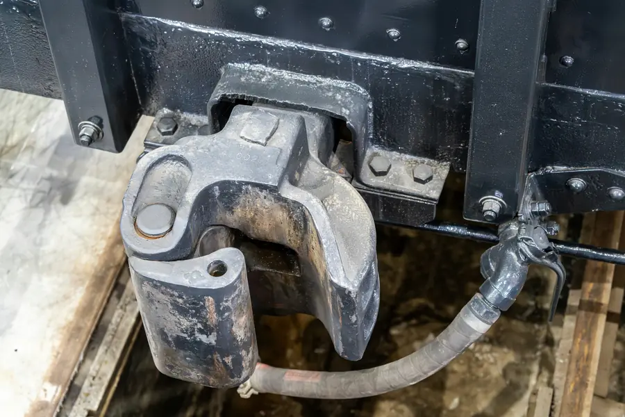 Close-up of a heavy-duty coupler between rail cars