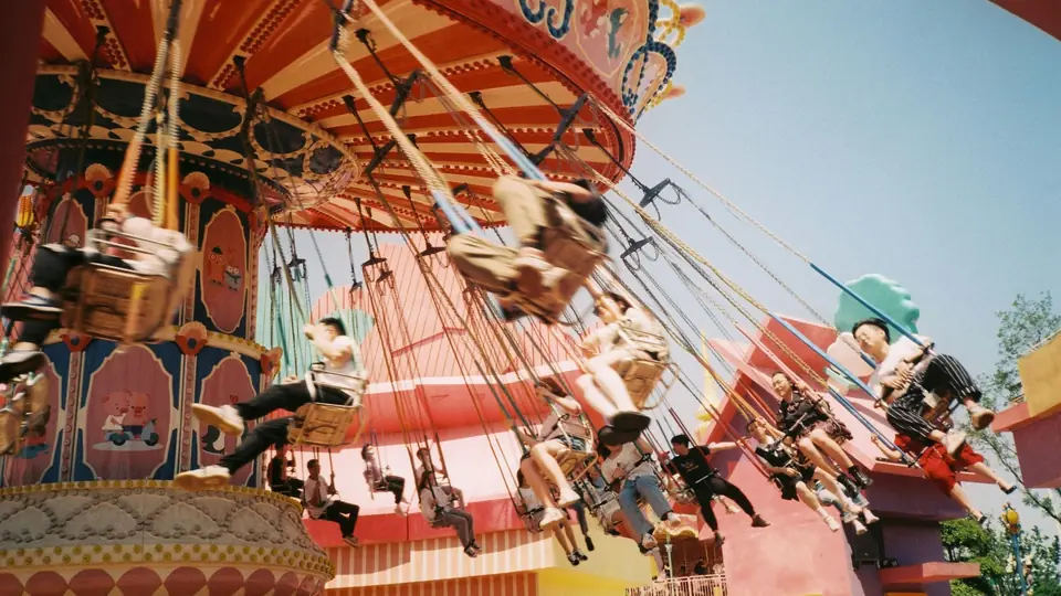 Riders on a swing carousel at an amusement park